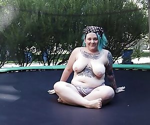 Fat Tattooed Milf Jumping and Stripping on a Trampoline